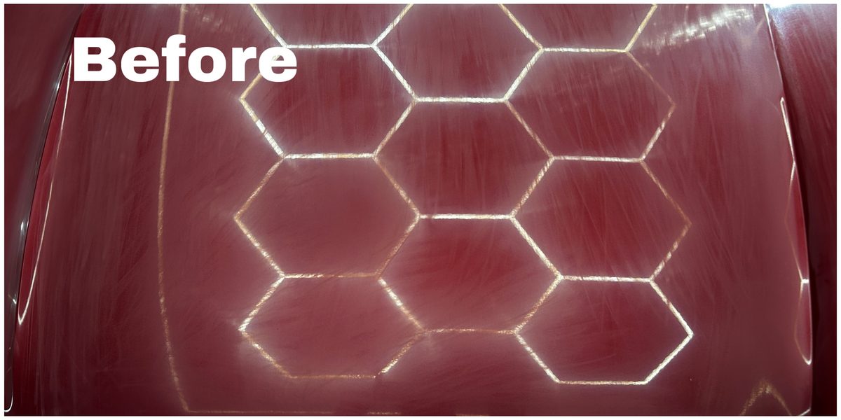 Before paint correction — hazy, heavily marred maroon bonnet under hexagon test pattern